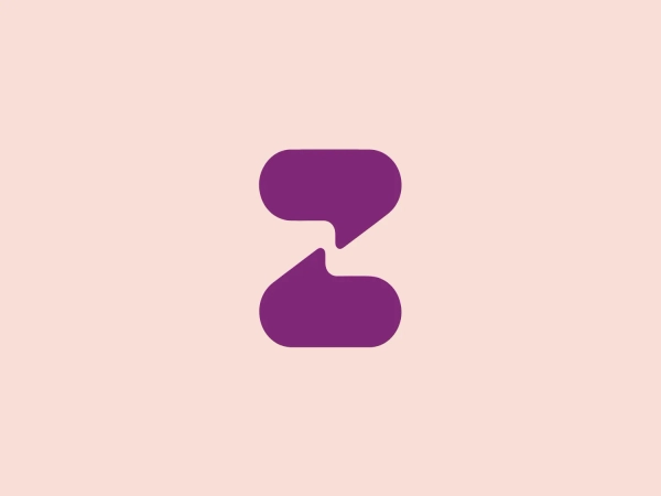 The Zula logo features two abstract shapes resembling speech or thought bubbles stacked with their points aligned. The upper, smaller shape is oriented horizontally, while the larger one below it has a vertical orientation. Both shapes have a modern, rounded design in a solid, deep purple color, providing a sense of unity and strength. The edges of the shapes curve inwards, creating an organic and dynamic appearance. This minimalistic design conveys communication, connectivity, and interaction.