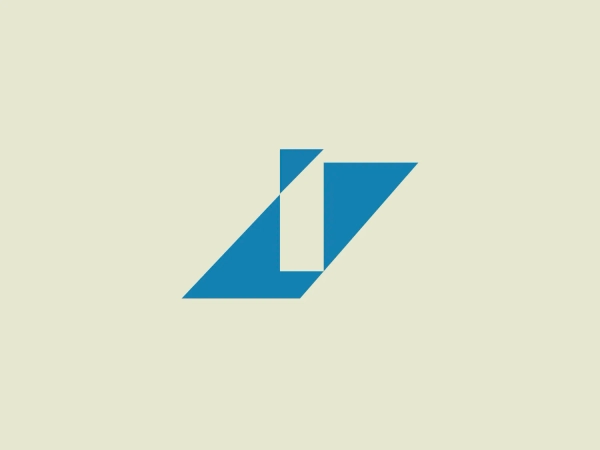 The Interdeco logo showcases a modern, minimalist stylized geometric design consisting of a bold, right-facing arrow shape created by abstractly combining a dark blue chevron and a vertical white element that bifurcates the figure. The design suggests forward motion or advancement with its sharp angles and clean lines, while the contrast between the blue and white creates a striking visual impact, giving the logo a professional and dynamic look. It is a strong, easily recognizable symbol that conveys precision and efficiency.