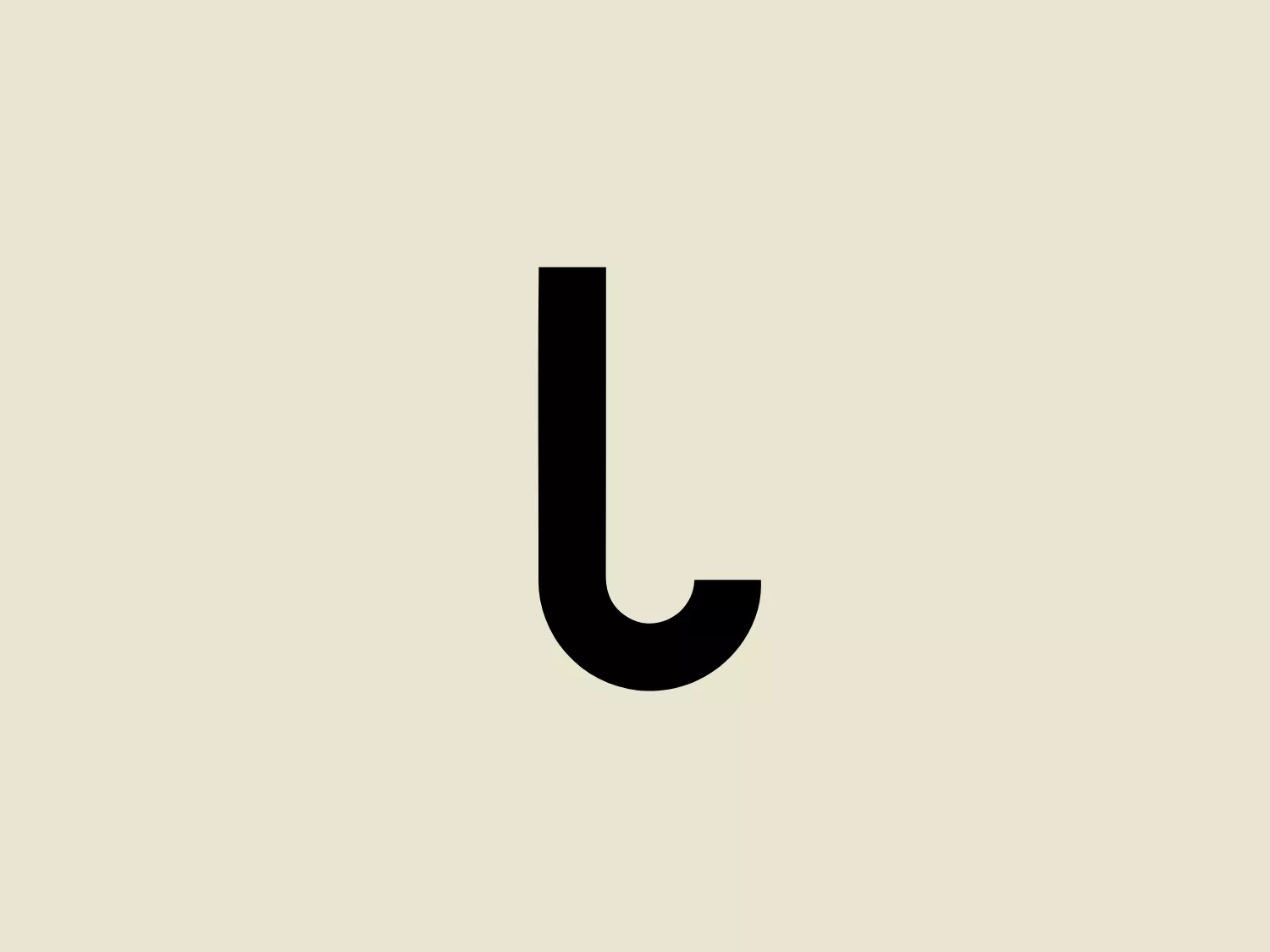 The KindTail logo features a minimalist, lowercase "l" with a strong, bold presence in solid black. The modern, sans-serif font and clean lines give it a contemporary appeal, while a gentle curve at the bottom softens its overall appearance. The thickness of the letterform provides a sturdy and grounded feel, conveying reliability and strength, making it stand out significantly against a light background.