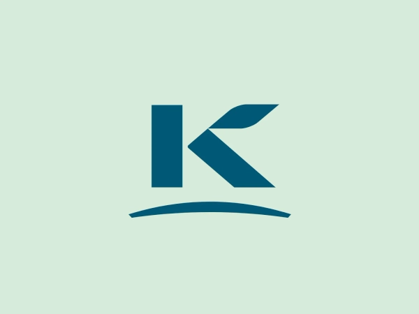The business name "Kerry" is visually represented by a stylized letter "K" with a modern, dynamic look. The logo features a deep teal color, projecting a professional and clean appearance. The "K" is complemented by a simple, curved line below, evoking a sense of stability and balance and suggesting a brand identity rooted in innovation and efficiency.