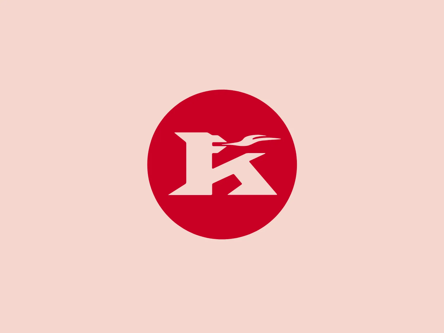 The Küppersbusch logo is a stylized monogram within a circular boundary. It features the letter "K" prominently in a bold, serif typeface with a dynamic, abstract element that resembles a swift stroke or possibly a bird in flight extending from the upper right portion of the "K". The overall design is simple yet striking, with the use of negative space enhancing the visual impact. The color of the letter and the accent is a solid, vibrant red, set against a clean, white background, which gives it a modern and energetic feel. The design conveys a sense of speed, precision, and efficiency.