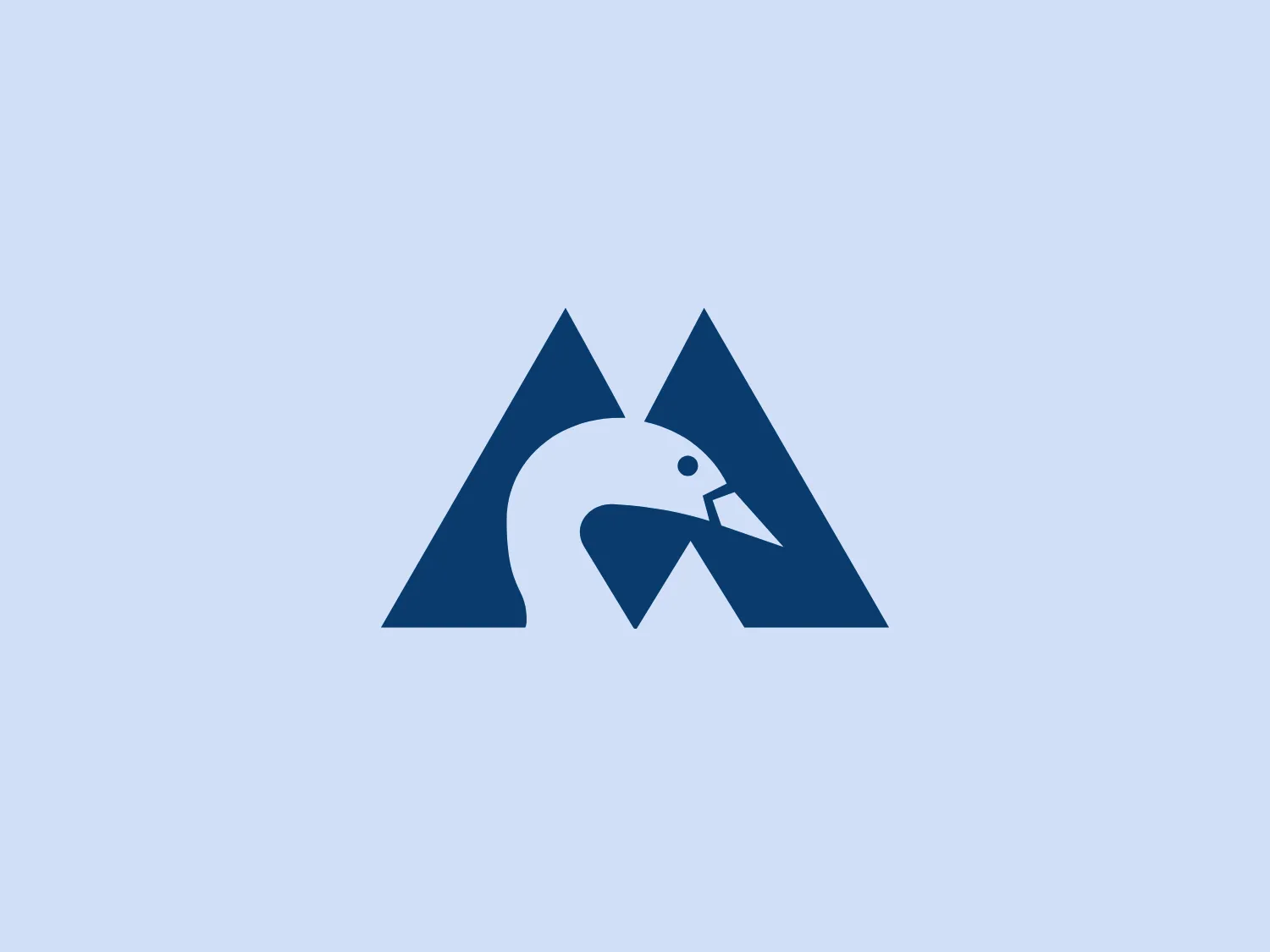 The Montshire Museum of Science logo is a stylized representation of what appears to be a mountain shape with a bird integrated into the design. There are two overlapping triangles forming the mountain, and a negative space within the right triangle depicts a bird in flight, with its wings angling upwards, giving an impression of ascent or progress. The design utilizes a single dark blue color, which adds to the professional and clean look. The use of negative space to create the bird is clever, merging the themes of nature and freedom.