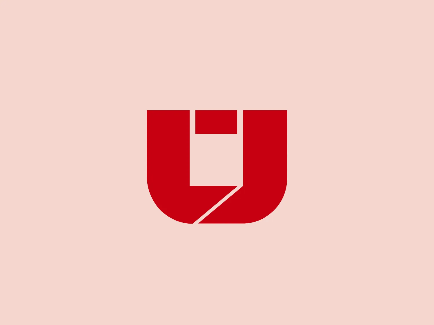 The Unifree logo features a bold, modern crest-like design in a deep red shield shape with a stylized white letter "U" embedded within it. The "U" is punctuated by a dynamic right-angled cut, giving it a sense of motion or transformation. This negative space implies the form of a forward-facing arrow or a check mark, suggesting progress, correctness, or advancement. The contrast between the red and the white is stark, and the overall design is clean and impactful, making it easily recognizable and potentially versatile for various applications. Given the color scheme, a light background would complement it well.