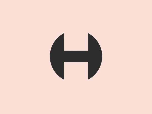 The Hackney Council logo showcases a bold, symmetrical, uppercase letter "H" in a deep, forest green color. The design is minimalist and modern with clean lines. The horizontal bar meets the vertical stems of the "H" in a distinctive way, connecting in the middle with slight notches or cutouts on the sides, giving the impression of forward movement or linkage. The thick lines suggest strength and stability. The simplicity of the design allows for versatile usage across various media.