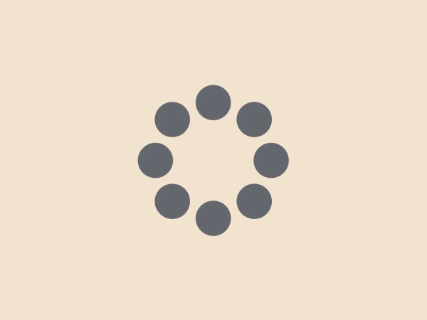The image displays a simple and modern logo consisting of nine circles arranged in a circular pattern, reminiscent of a flower or a propeller. The central circle is slightly smaller than the outer eight circles, which are evenly spaced and encircle the center. This creates a sense of balance and uniformity. The color of the Memorex logo is a monochromatic shade of medium grey, which gives it a professional and versatile look that could fit various contexts. The design's simplicity allows for easy recognition and potential scalability without losing clarity.