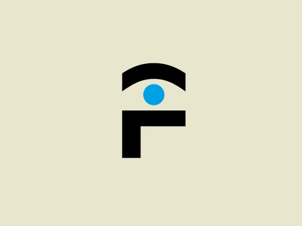 The Foveon logo features a bold, minimalistic design consisting of geometric shapes. It is comprised of an upper semicircle in black, beneath which sits a smaller, solid blue circle slightly off-center to the right. Directly below the blue circle is a thick, black letter "F" without any serifs and with the horizontal line aligned with the center of the blue circle. The deliberate use of negative space between the elements creates a modern and clean look. The color palette is simple and consists of black and a vibrant shade of blue, which gives the logo a strong, professional feel.