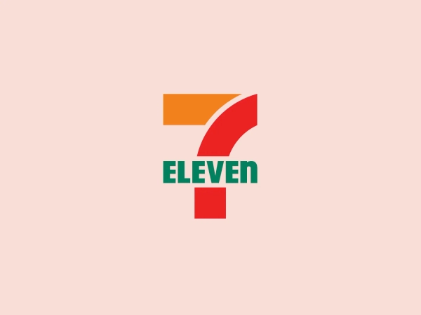 The 7 Eleven logo showcases a bold, graphic representation of the numeral 7 in orange, red, and green hues, creating a stylized, angular form. Below the numeral, the uppercase green letters spell out "ELEVEN," matching the green color of the numeral. This modern and striking design utilizes primary and secondary colors for strong contrast and high visibility, making it memorable and easily recognizable.