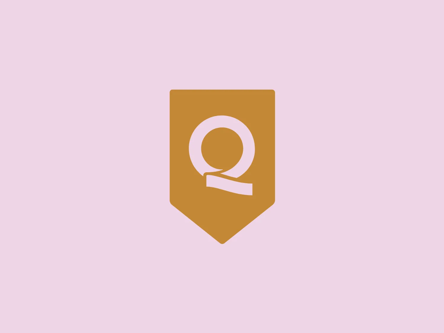 The Calidad Turística logo is a minimalistic shield-like shape featuring the stylized letter 'Q' in a clean, modern font, with the tail of the 'Q' cutting through the letter, providing a sense of movement. The overall shape of the logo is reminiscent of a medieval crest or heraldic symbol, which gives it an authoritative and established feel. The color is a warm, muted shade of orange-brown, evoking a sense of reliability and trustworthiness. There are no additional embellishments, making the design sleek and adaptable to various uses.