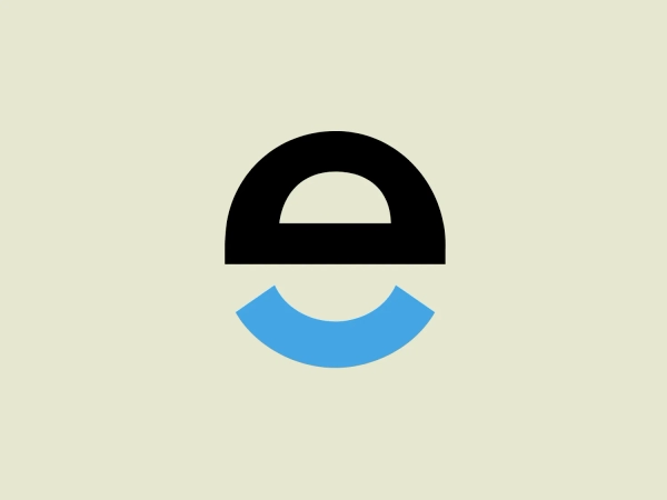 The logo for Egloff Druck features a minimalist design with two juxtaposed shapes—a semicircle in a solid black color on the top and a semicircle in a bright blue color on the bottom—creating a balanced and geometrically harmonious look. The use of negative space between the two shapes forms a circular outline suggesting a complete shape split into two contrasting hues. The overall design aesthetic is modern and simplistic, with a stark contrast between the black and blue elements, which adds a dynamic and professional feel to the logo.