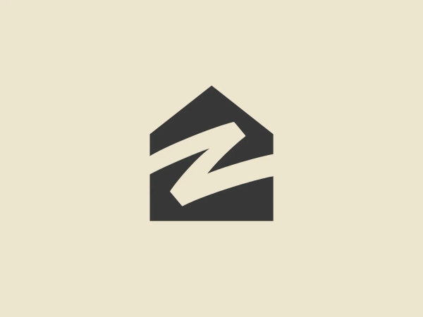 The Zillow logo features a bold, stylized mark composed of geometric shapes that form an abstract representation of a house or an arrow pointing upward, conveying growth or stability. Its design is modern and dynamic, utilizing sharp angles and straight lines. The logo is monochromatic, with a vibrant shade of blue that suggests professionalism and trustworthiness. There is a sense of movement implied by the white space that creates a forward-moving arrow within the upper shape. This logo would stand out well against a neutral background.