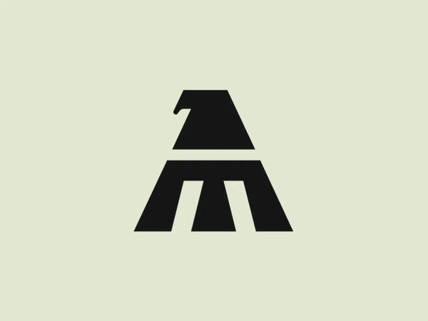 The Mexicana logo is a stylized letter "A" depicted with strong geometric forms in a deep navy blue color. It consists of a solid triangular shape that serves as the main body, with a horizontal line that segments the triangle into two parts, giving the illusion of a letter "A" without the need for the crossbar. The upper part suggests the peak of the "A" and it incorporates a subtle negative space that represents an animal's ear, cleverly creating a dual symbolism. The overall design aesthetic is modern, minimalistic, and bold, with a focus on simplicity and clever use of positive and negative space.