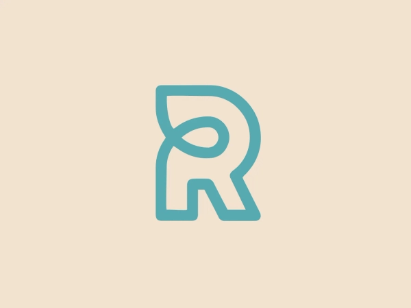 The Road Media Group logo features a stylized letter 'R' with a modern and fluid design. The letterform has soft, rounded edges and a distinctive cut-out on its right leg, giving it a unique and contemporary appearance. Its color is a soothing, pastel teal with a slight gradient that adds depth to the flat design, making it look sleek and professional. The thickness of the line varies slightly throughout the design, which accentuates the letter's curves and edges, enhancing its dynamic feel.