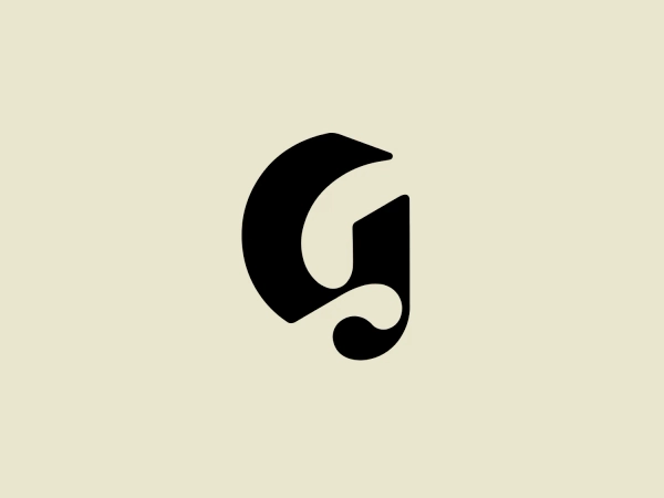 The logo presented is a stylized letterform that appears to represent the lowercase letter "g." It features a bold, modern design with smooth, flowing lines that curve around to form a distinctive, abstract shape. The main element of the Glossier logo is a solid black with clean edges, emphasizing its minimalist aesthetic. The logo's smooth curves and lack of additional embellishment suggest a sleek, contemporary brand identity.