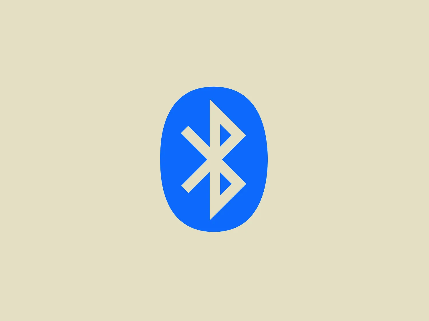 The Bluetooth logo features a stylized white Bluetooth symbol centered within a bright blue oval. The Bluetooth icon itself consists of a pointed line shape and two angular chevrons interlocked, creating a symmetric and abstract representation of the letter 'B'. The blue oval has no border and its edges are smooth, creating a simple yet bold contrast against the white icon. The logo exudes a modern and clean aesthetic with its minimalist design and vibrant color, which would stand out well against a complementary background.