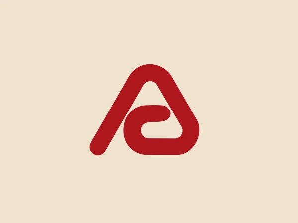 The logo for Anthro Corporation features a stylized, bold, red letterform that seamlessly combines elements of the letters "A" and "e." The dominant "A" has two diagonal lines meeting at a rounded apex, with a lowercase "e" nested within its negative space. The color is a solid, vivid red with no gradients or shading, resulting in a striking and modern look. This design is simple, yet the negative space within the "A" creates a visually interesting feature. Given the red color of the logo, a subtle and light background would complement it well without causing a visual clash.