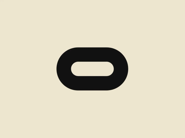 The Oculus logo is a simplistic and modern design featuring a solid black ellipse with a gap in its center, creating an abstract letter "O". The design is flat with no gradients or shadows, giving it a clean and minimalist appearance. No additional elements or embellishments are present, ensuring the logo's versatility and scalability for various applications. The use of negative space to imply a letter is a clever touch that adds a level of sophistication to the overall design.