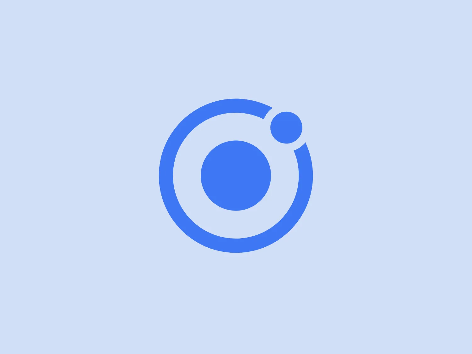 The Ionic logo features a stylized depiction of an atom or planetary orbits, with a central blue circle representing either the nucleus or a planet, which is encircled by two bold blue rings resembling the orbits. Within one of the rings, a smaller circle floats as if to represent an electron or a moon in orbit. The overall aesthetic is modern and simple, employing varying shades of blue for a clean, professional appearance. The design suggests a theme of science, technology, or possibly astronomy, due to its resemblance to atomic structures or celestial bodies.