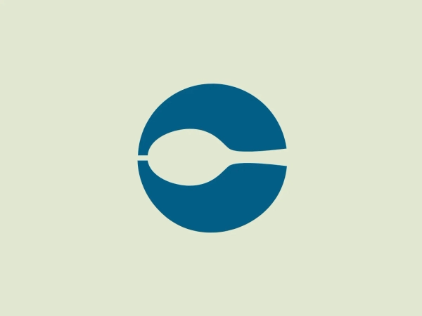 The Centerplate logo features a modern and minimalistic design, consisting of a deep shade of blue circle with a white abstract shape resembling a tilted seed or a simplified representation of the infinity symbol cutting through the center. The color scheme of blue and white conveys trust, professionalism, and clean contrast, creating a sense of fluidity and continuity within the circular boundary. The soft and subtle hue of #E2E8D2 is recommended as a background color to complement the logo, maintaining its simplicity and sophistication.