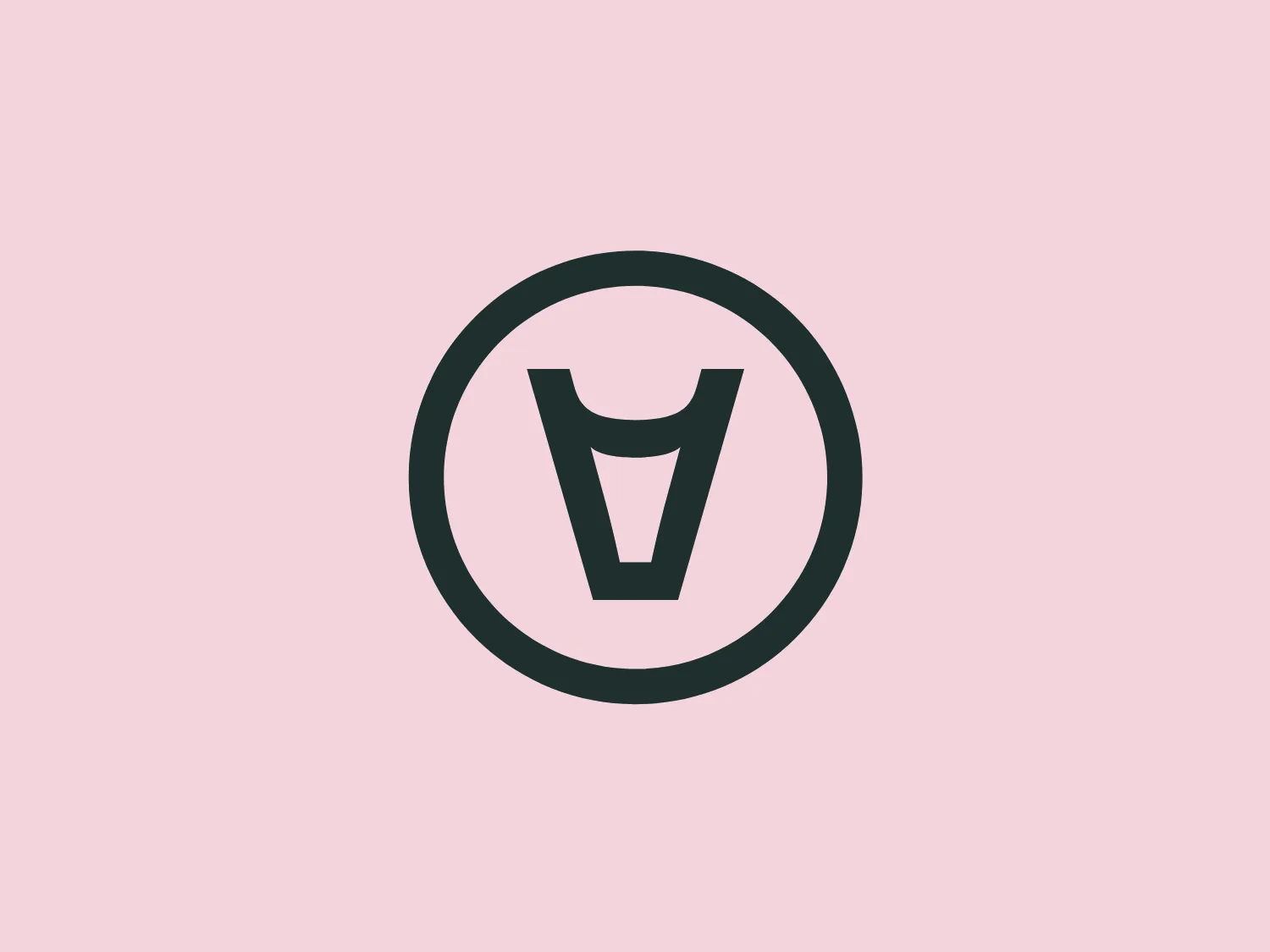 The Aleph Farms logo features a stylized letter 'V' centered within a circular boundary. The 'V' has a unique design, with the top edges angled sharply and the bottom forming a solid base that resembles a cup or a shield. Both the 'V' and the enclosing circle have a bold, thick line, suggesting strength and stability. The overall design is minimalistic and modern, with a monochromatic color scheme. The color appears to be a dark shade of gray or black, which stands out against a clean, white background. This simplicity allows it to be versatile across various applications.