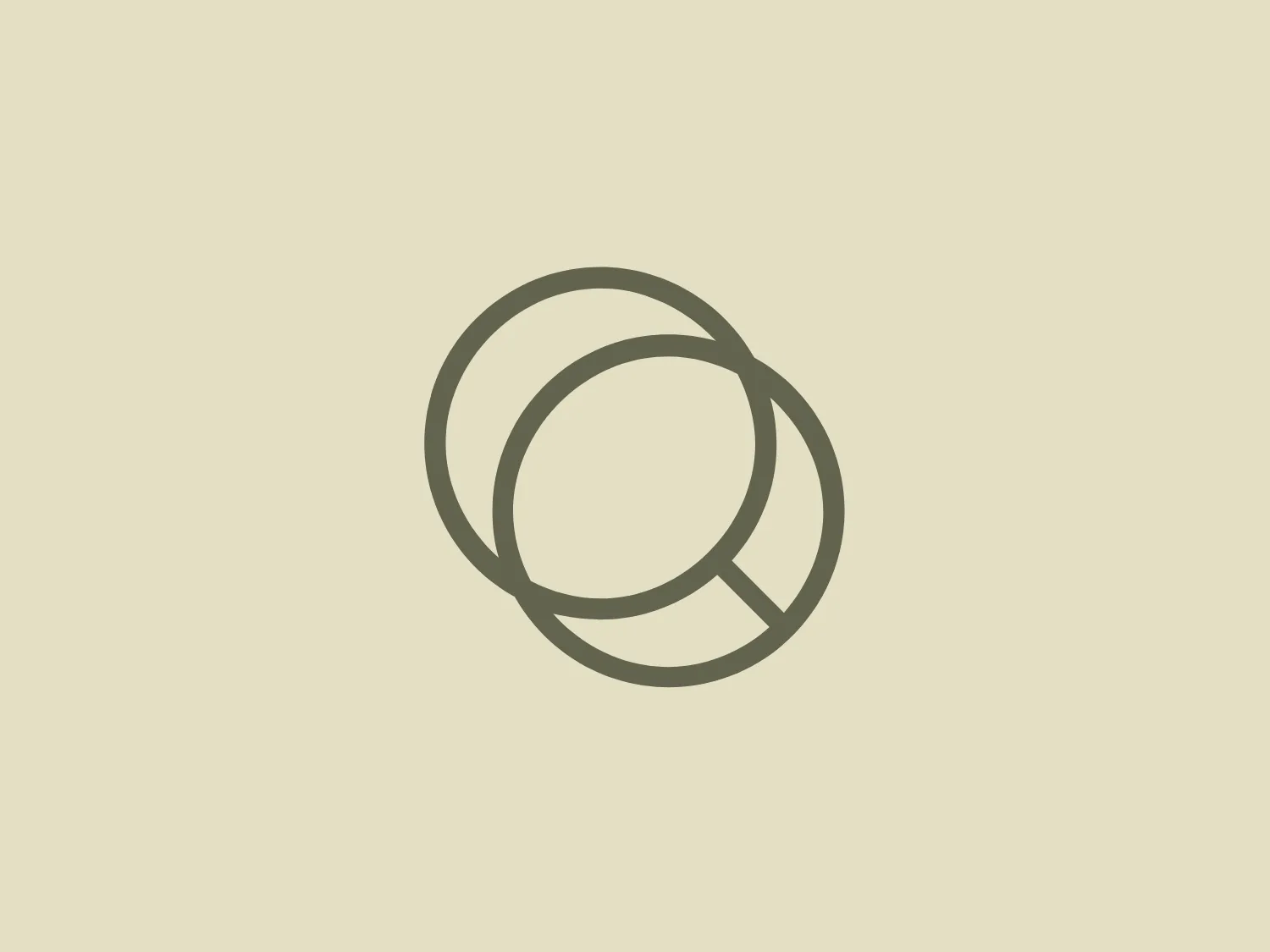 The A Equipa logo features a pair of interconnected rings, with the left ring overlapping the right. Both rings are smooth and have a consistent width, giving the design a sleek and modern look. The color of the logo is a muted, earthy shade, akin to sage or grayish-olive, which conveys an organic and natural vibe. The simplicity of the shapes and the subtlety of the color allow the logo to evoke a sense of harmony and balance, suitable for a brand aiming for a clean and minimalist aesthetic.