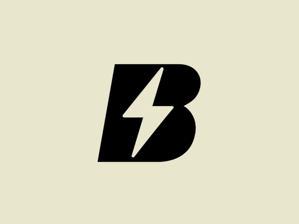 The BETA Technologies logo features a bold, solid black letter "B" with a white lightning bolt cutting through its center, creating a modern and minimalist design. The stark contrast between the black and white elements emphasizes the strong visual impact of the logo. The lightning bolt infuses a sense of power and energy, suggesting dynamism and force. The classic, rounded attributes of the "B" combined with the edgy, contemporary feel of the lightning bolt create a striking visual identity for the business.