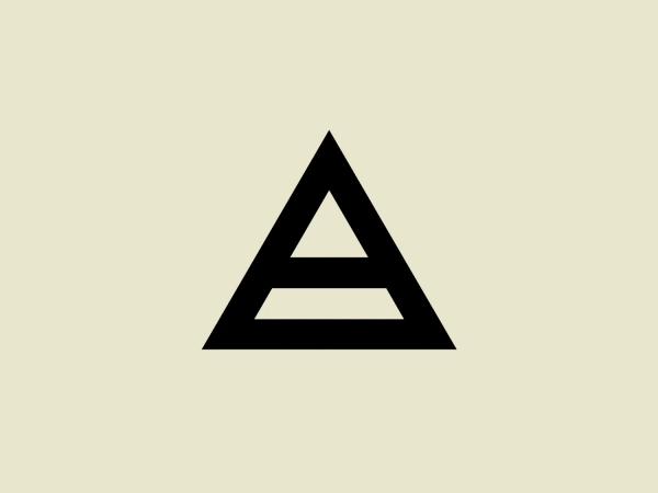 The Avrett logo features a bold, black equilateral triangle with a smaller, inverted white equilateral triangle centered within it, creating a strong sense of contrast and geometric simplicity. The modern and minimalist design, coupled with a stark monochromatic color scheme, exudes a sense of stability and balance through the use of basic geometric shapes and symmetry.