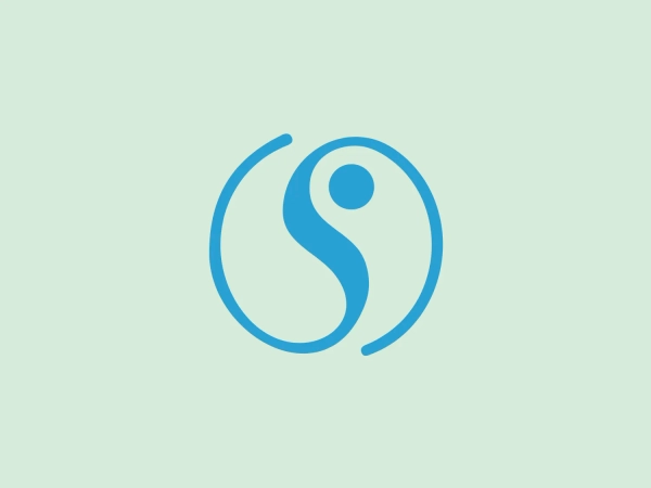 The Sheló Nabel logo features a stylized representation of a yin-yang symbol, commonly associated with balance and harmony. The design consists of two swirling shapes, interlocking to form a circle, in a bright and crisp shade of blue. Inside each swirling shape is a small contrasting color dot, maintaining the traditional look of the yin-yang symbol. The lines are smooth and have a moderate thickness, contributing to an overall modern and clean aesthetic. The simplicity of the design ensures versatility across various mediums, and a complementary background is important.