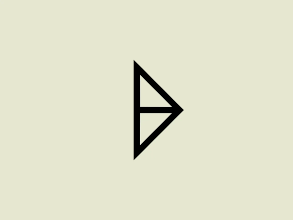 The Atelier B29 logo consists of a bold, black stylized arrowhead pointing to the right. It has a modern, geometric design with sharp angles and clean lines. The arrowhead is formed by an isosceles triangle with a smaller, right-angle triangle cut out from the left side, creating a sense of movement and directionality. The overall aesthetic is minimalist and dynamic, suitable for a variety of applications where a forward-thinking or progressive identity is desired.