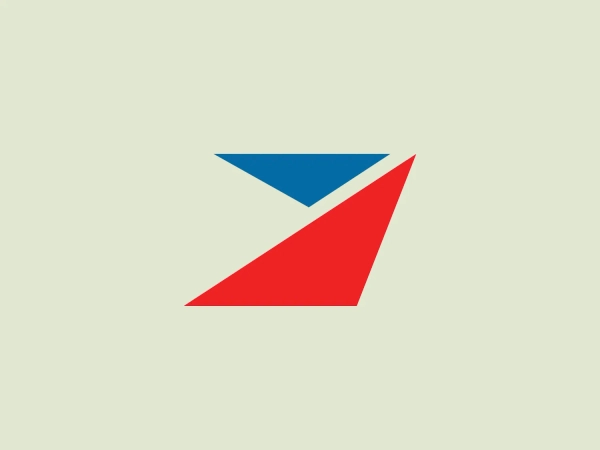 The Tirsan logo features a stylized geometric bird in flight, composed of three flat shapes. The bird’s body and wings are depicted by a large red triangle on the bottom right, symbolizing motion or advancement. Above this, a smaller blue triangle forms what appears to be the bird’s head, adding a sense of direction or focus. The use of red suggests energy or passion, while the blue adds a professional or trustful quality. The overall design is modern, minimalistic, and dynamic, likely representing freedom, speed, and precision. The shapes are arranged asymmetrically, giving the impression of upward movement or taking off.