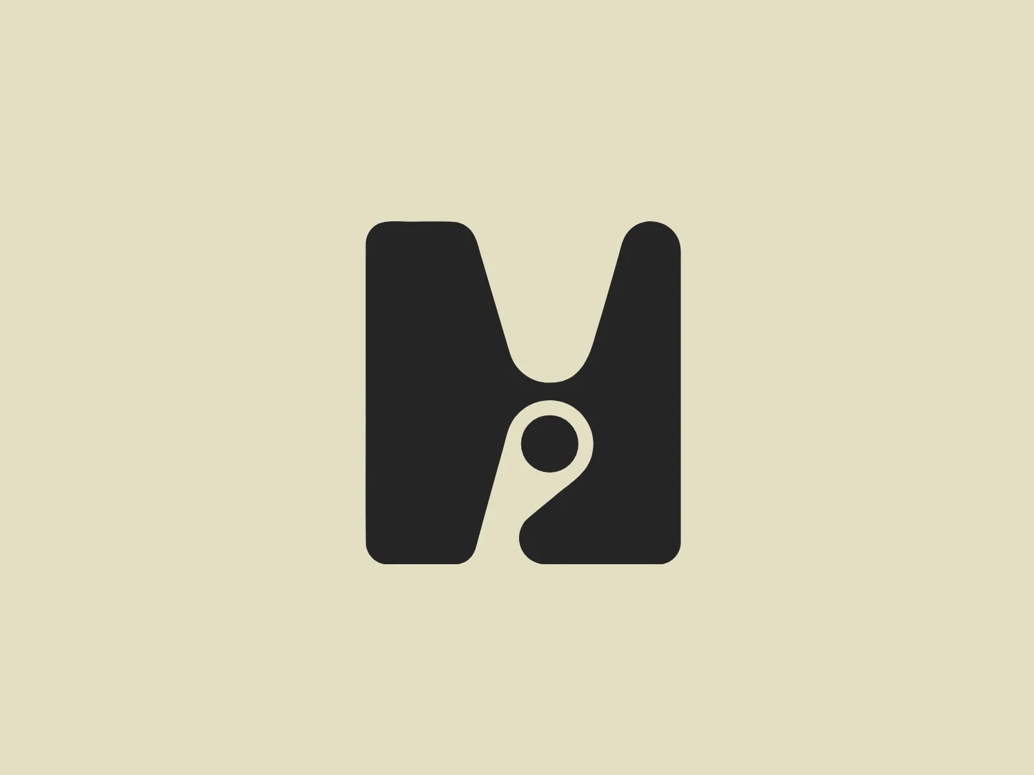 The Holistic London logo features a contemporary and minimalistic stylized letter "M" in black. The right side of the "M" is crafted to suggest a lowercase "e," utilizing a circular negative space that also resembles an apostrophe, adding a sense of playfulness and duality. The smooth shapes and clean lines give the logo a modern and sleek appearance, making it versatile with a simplistic color scheme suitable for a neutral yet contrasting background.