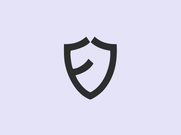 The Eloka Logistics logo features a stylized shield design made of bold, blue lines that form both the outline of the shield and an abstract, capital letter 'E' at the center. The 'E' is composed of three disconnected parts: a horizontal bar at the top, a diagonal middle piece that doubles as part of the shield's interior design, and a shorter bottom bar. The color is a strong, medium shade of blue that conveys trust and reliability. The clean lines and minimalistic style give the logo a modern and professional appearance. It suggests protection, security, and strength.
