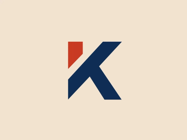 The Kemper logo emphasizes a bold, navy blue "K" with sharp angles, connoting strength and stability. The design also incorporates a smaller, triangular red shape on the upper left side, adding a punch of energy and attention to the logo. The contrast between the red and navy blue gives the logo an assertive and professional appearance.