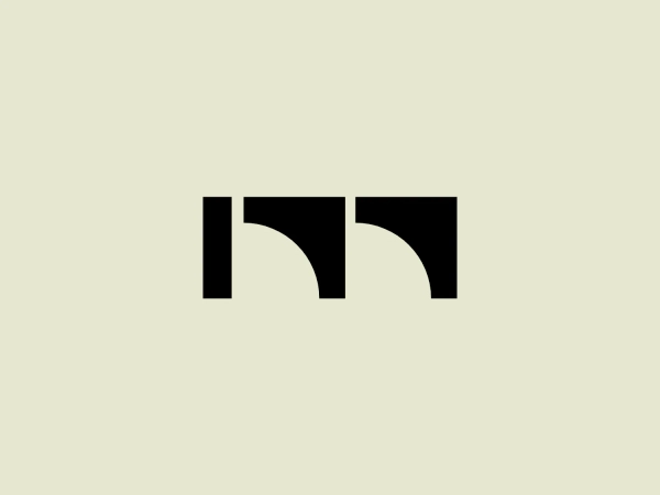 The Modterra logo is a simple, monochromatic design consisting of black bold shapes on a white background. The design features what appears to be a stylized representation of the letters 'nn' with the first 'n' mirrored and attached to the second 'n'. The gap between the two 'n's creates a bridge-like negative space. The logo has a modern and minimalistic style, using solid geometric shapes to create a clean and easily recognizable symbol.