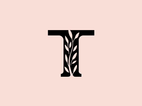 The image is a monochromatic logo featuring the business name "Thymes" in a stylized letter "T." The logo has a bold, black design with a series of organic, leaf-like shapes cut out from the body of the letter to form an intricate pattern. The leaves create a sense of growth and natural elegance within the otherwise geometric character. The overall design aesthetic marries the simplicity of the letterform with the complexity and grace of nature. This blend of natural motifs with modern design gives the logo a unique and memorable look, appropriate for a brand emphasizing eco-friendliness, growth, or wellness.