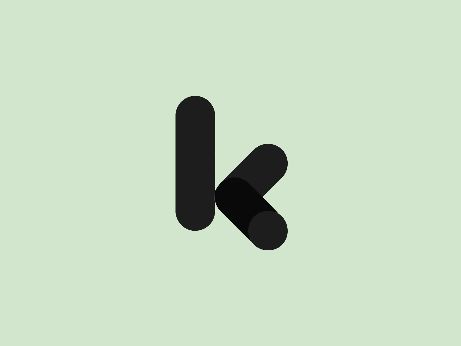 The image depicts a bold, stylized logo consisting of two overlapping shapes in shades of blue. The shapes form an abstract capital letter "K," with one standing vertical and the other diagonally. The design creates a modern and dynamic feel through geometric simplicity and a deep color palette, with the right shape featuring a gradient from royal blue to navy for a three-dimensional effect.