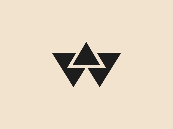The Wastequip logo features a stylized symmetrical design that resembles a geometric bird in flight, with a central triangle flanked by two larger, outstretched wings. The logo is monochromatic, employing a deep navy blue color. Its angular, sharp edges convey a sense of precision and modernity, while the interplay of shapes within the wings gives an impression of depth and movement. The central triangle arguably acts as both the body of the bird and an upward pointing arrow, suggesting upward momentum or growth. Considering its strong geometric lines and bold color, a light and slightly warm background would complement it well, providing enough contrast to enhance its visibility without overshadowing the design's intrinsic boldness.