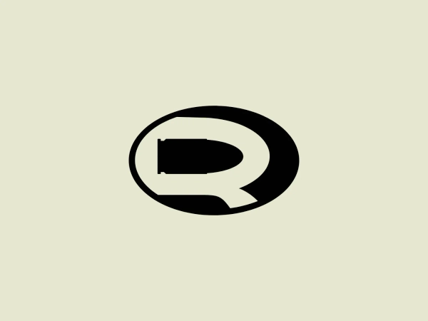 The logo for Remedy Games is a bold and modern depiction of the letter 'Q'. The 'Q' is styled with a thick, black stroke and features a solid black rectangular shape inside the circular part of the letter, giving it a distinctive, abstract appearance. The tail of the 'Q' doesn't loop, but instead extends slightly outside of the oval shape, adding an edgy twist to the traditional letter form. The black on white provides a strong contrast that makes the logo stand out. The overall aesthetic is sleek, contemporary, and could be associated with a tech-savvy or design-focused brand.