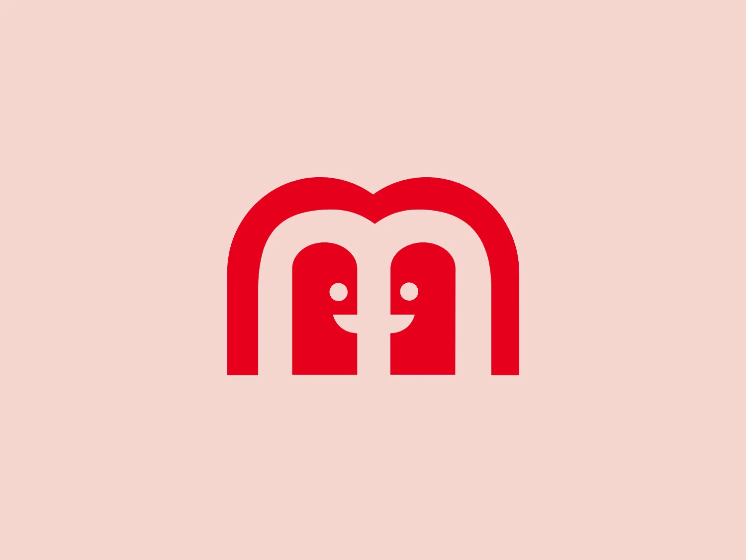 The Mattel Games logo presents a stark, symmetric design featuring two abstract figures that mirror each other with a resemblance to the letter 'M'. The figures have rounded tops that suggest a friendly and approachable brand personality. The central part of their bodies forms a subtle heart shape, indicating a possible emphasis on connection, love, or health. Made up of smooth, continuous lines, the figures possess a modern and clean aesthetic. They are set in a bold red color that stands out and conveys a sense of energy, passion, or importance. No other graphical elements or text distract from the central figures, which keeps the design minimalist and focused.