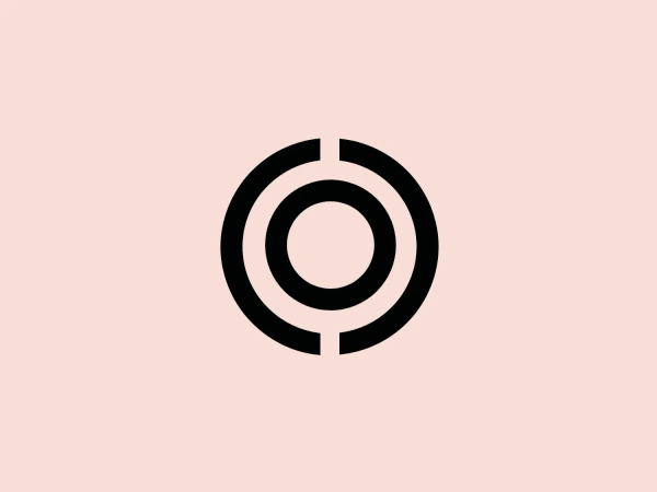 The Osko logo is a minimalist and modern design comprised of three concentric elements. It features a bold black circle as the outermost shape, followed by a thinner black ring, and a solid black dot at the center. The strategic breaks in the rings create the impression of a stylized letter "C" or "G," offering versatility in its interpretation. With its strong contrast and minimalist aesthetic, the logo is suitable for diverse brand representations across various mediums, and would complement well with a subtle and light background.