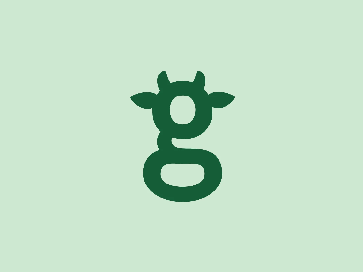 The Greencow logo showcases a stylized letter "g" that resembles a friendly alien or creature with two pointy ears and wide, circular eyes. The design aesthetic is playful and modern, with a solid forest green color (#2E8B57) filling the form, giving it a vivid and bold appearance. The letter "g" appears to be standing, infusing personality into the typography. The simplicity and smooth curves of the design allow for easy recognition and would appeal to a youthful audience or a brand with a fun, imaginative identity. Hexcode: #E2E8D2