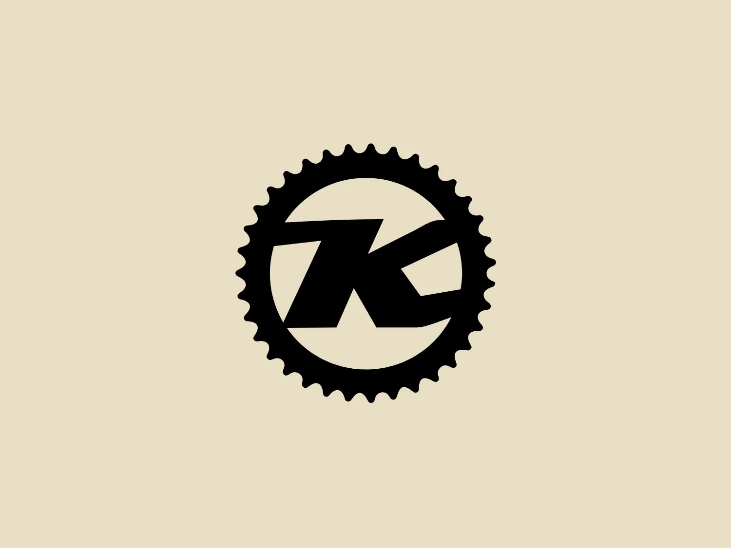 The Kona Bikes logo features a bold stylized monogram of the letters "KB" enclosed within a gear-like circular border, reflecting an industrial, mechanical, or technical theme. The monochromatic design utilizes stark black against a plain background, with sharp edges and dynamic negative space for a modern and aggressive character. The gear border adds complexity and implies craftsmanship or engineering.