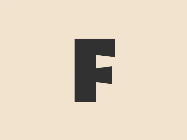 The Folger Shakespeare Library logo features a bold, uppercase letter 'F' with a right-angled notch cut out from the top right corner, creating a visual effect reminiscent of a flag or an arrow pointing to the left. This design gives a sense of motion or progress. The 'F' is presented in a vibrant, solid red color, making it stand out with a striking simplicity. The shape is modern and geometric with clean lines, suggesting a contemporary and dynamic brand identity.