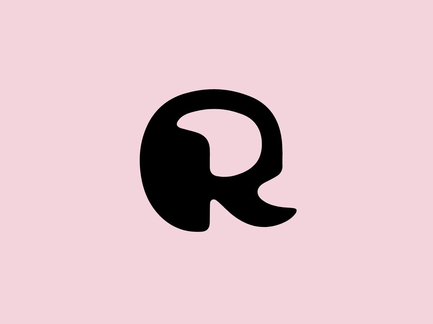 The image depicts the Rockella logo, a solid black stylized letter "R" with bold, smooth, flowing curves and a distinct ear-like protrusion on the upper left, giving it a unique and contemporary appearance. The design exudes modern simplicity with an artistic twist.