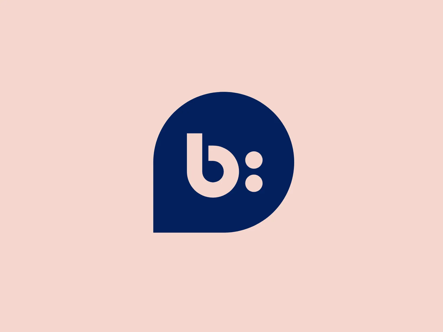 The Bazaarvoice logo features a lowercase 'b' in white with a colon punctuating it to its right, inside a rounded navy blue shape that resembles a speech bubble. The design aesthetic is minimalistic and modern, using a bold sans-serif font that communicates clarity and succinctness. The shape is organic with a comfortable roundness that invites friendly communication. The color contrast between the white and the deep blue gives the logo a professional yet approachable look.