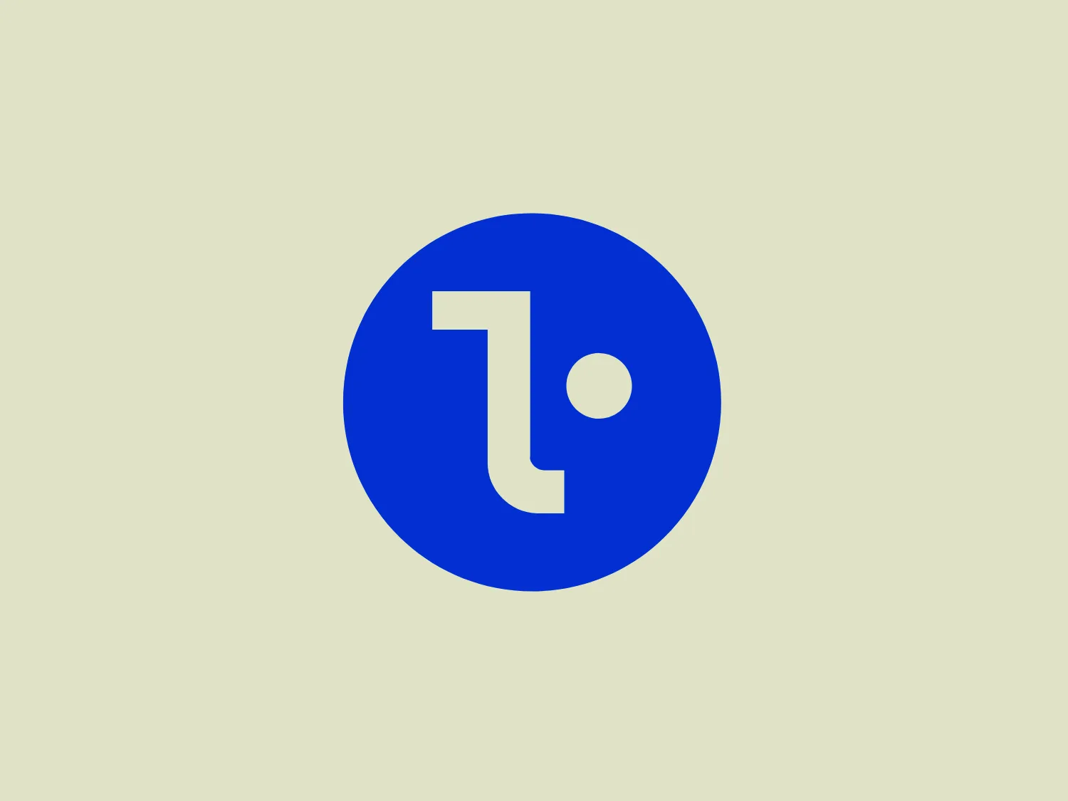The logo in the image features a stylized lowercase letter "t" in white, with a modern and minimalist design aesthetic, set against a bold blue circular background. The "t" is constructed with a distinctive curve at the bottom, creating a dynamic visual flow, and includes a dot that seems to represent either a lowercase "i" or a period, adding a unique character to the design. The contrast between the white and blue creates a striking visual impact, demonstrating a clean and simple yet effective branding approach.